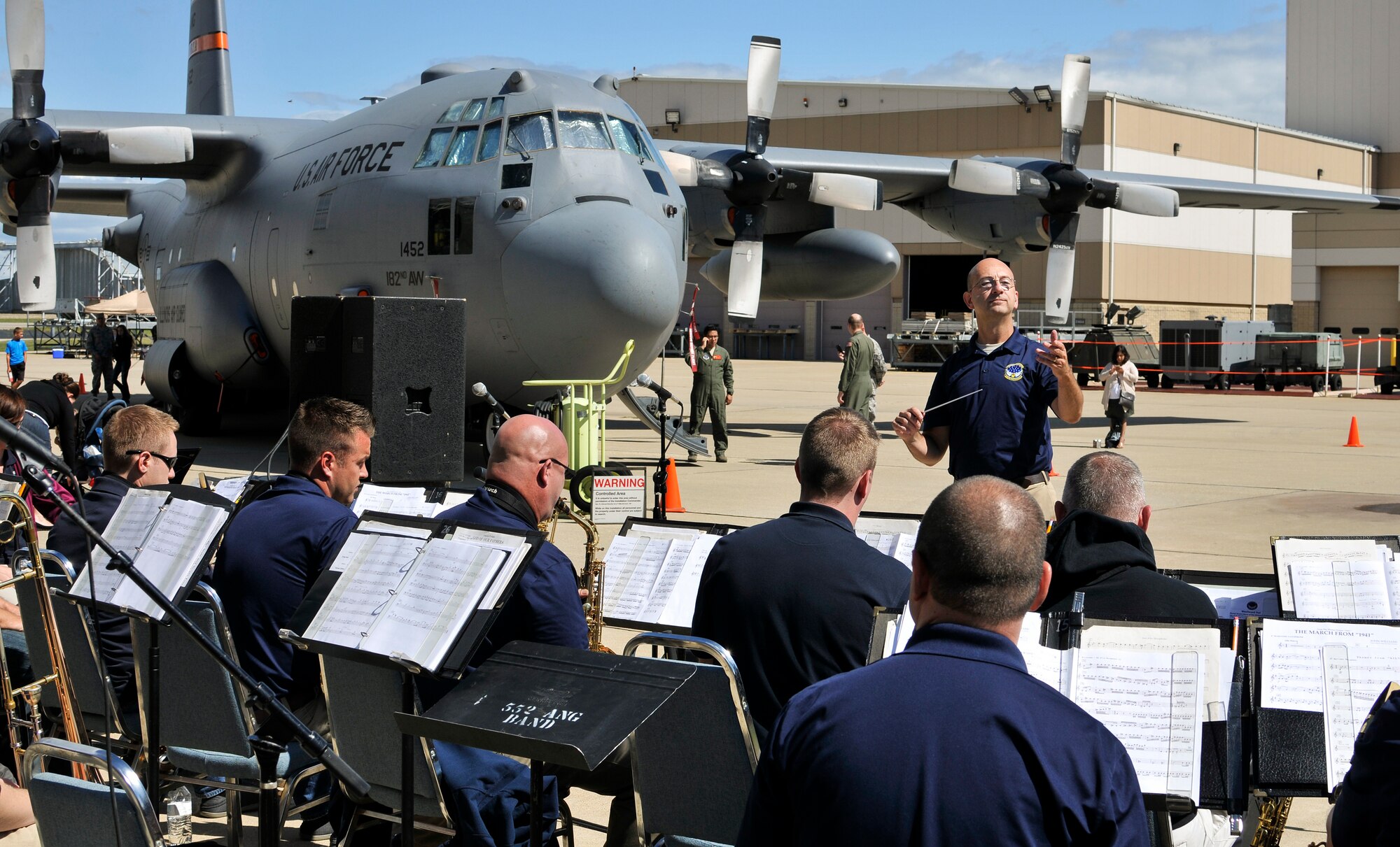 U.S. Air Force Lt. Col. Bryan M. Miller, commander of the 566th Air Force Band, Illinois Air National Guard, conducts a performance during Wingman and Family Day at the 182nd Airlift Wing, Peoria, Ill., Sept. 12, 2015. The event was organized to promote resiliency in Airmen and their friends and family. (U.S. Air National Guard photo by Staff Sgt. Lealan Buehrer/Released)