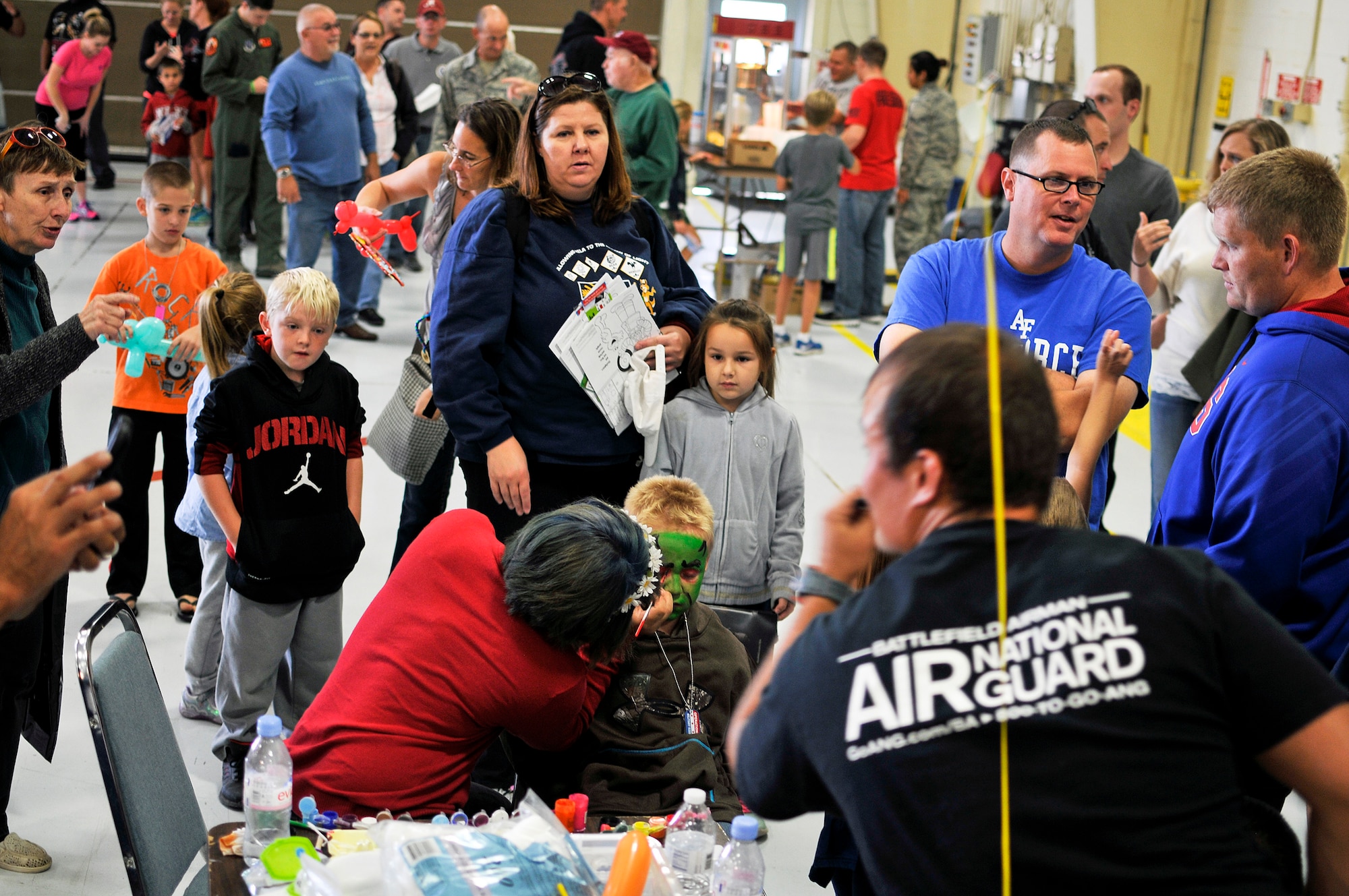 Friends, family and unit members of the 182nd Airlift Wing, Illinois Air National Guard, partake in popcorn, face painting and balloon animals during Wingman and Family Day at the 182nd Airlift Wing, Peoria, Ill., Sept. 12, 2015. The event was organized to promote resiliency in Airmen and their friends and family. (U.S. Air National Guard photo by Staff Sgt. Lealan Buehrer/Released)