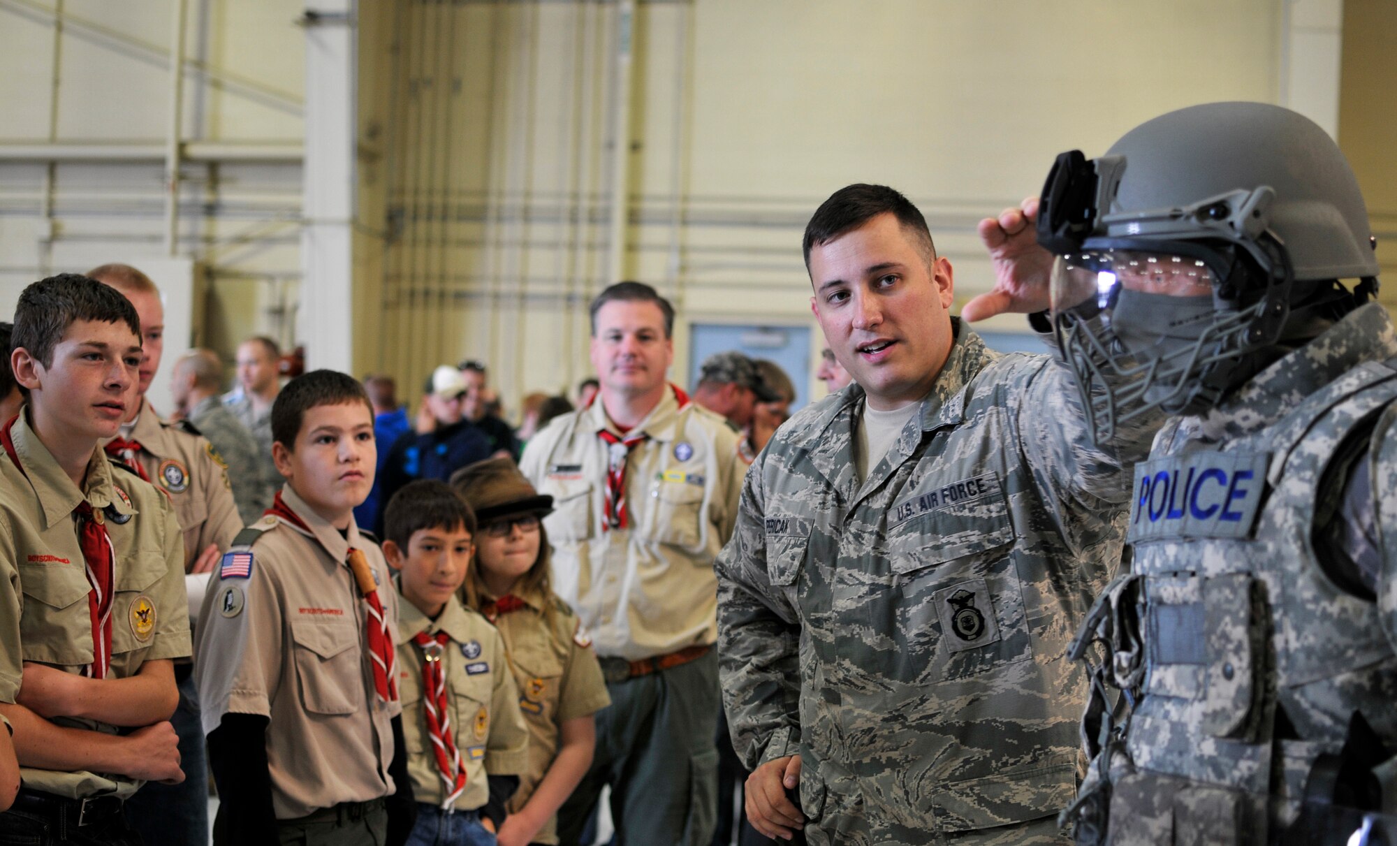 U.S. Air Force Senior Airman Scott J. Pericak, security specialist with the 182nd Security Forces Squadron, Illinois Air National Guard, explains his unit’s domestic operations uniform configuration during Wingman and Family Day at the 182nd Airlift Wing, Peoria, Ill., Sept. 12, 2015. The event was organized to promote resiliency in Airmen and their friends and family. (U.S. Air National Guard photo by Staff Sgt. Lealan Buehrer/Released)