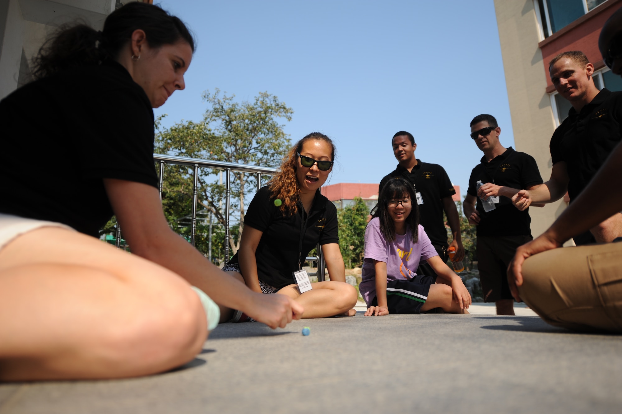 Airmen assigned to the 80th Fighter Squadron, 8th Fighter Wing, Kunsan Air Base, Republic of Korea, play gonggi with children at a Gunsan City welfare facility Sept. 19, 2015. Approximately 20 volunteers played soccer, basketball and gonggi with elementary, middle and high school students. Organizations from the 8th FW regularly volunteer time to enhance relationships with the local community and make the wing better. (U.S. Air Force photo by Master Sgt. David Miller)