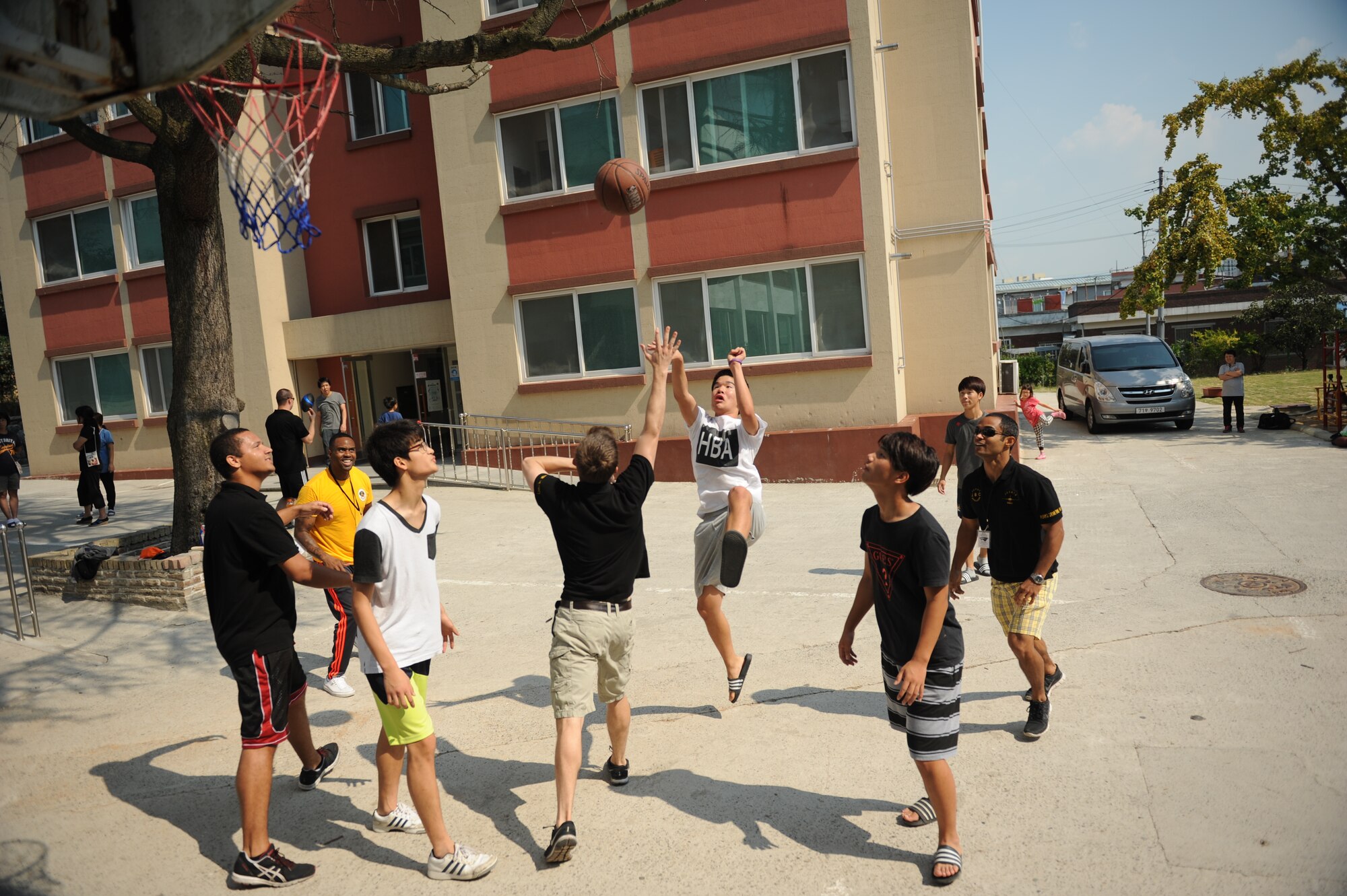 Airmen assigned to the 80th Fighter Squadron, 8th Fighter Wing, Kunsan Air Base, Republic of Korea, play basketball with children at a Gunsan City welfare facility Sept. 19, 2015. Approximately 20 volunteers played soccer, basketball and gonggi with elementary, middle and high school students. Organizations from the 8th FW regularly volunteer time to enhance relationships with the local community and make the wing better. (U.S. Air Force photo by Master Sgt. David Miller)