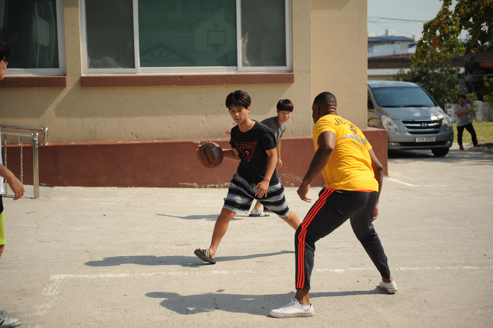 Airmen assigned to the 80th Fighter Squadron, 8th Fighter Wing, Kunsan Air Base, Republic of Korea, play basketball with children at a Gunsan City welfare facility Sept. 19, 2015. Approximately 20 volunteers played soccer, basketball and gonggi with elementary, middle and high school students. Organizations from the 8th FW regularly volunteer time to enhance relationships with the local community and make the wing better. (U.S. Air Force photo by Master Sgt. David Miller)