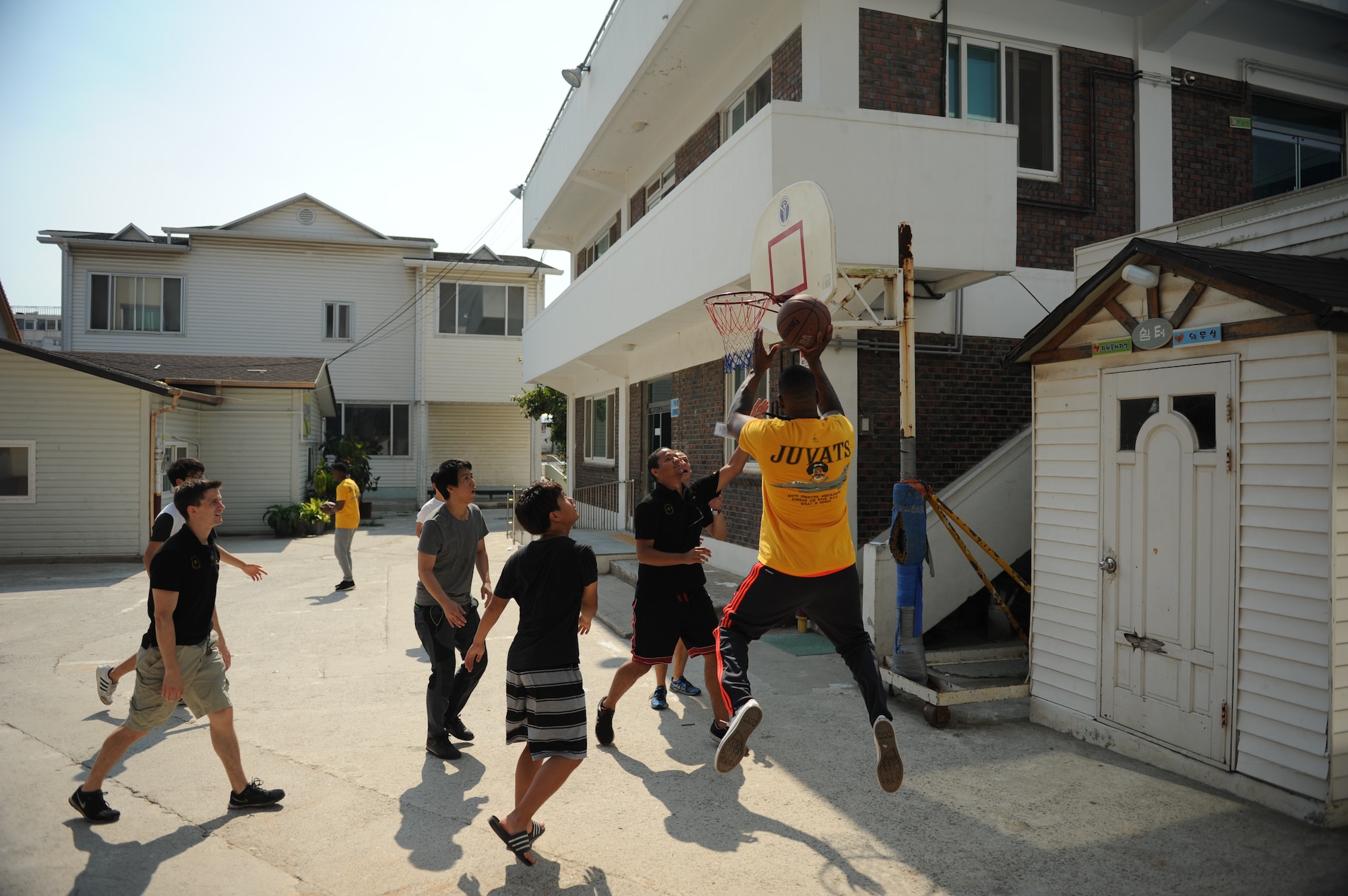 Airmen assigned to the 80th Fighter Squadron, 8th Fighter Wing, Kunsan Air Base, Republic of Korea, play basketball with children at a Gunsan City welfare facility Sept. 19, 2015. Approximately 20 volunteers played soccer, basketball and gonggi with elementary, middle and high school students. Organizations from the 8th FW regularly volunteer time to enhance relationships with the local community and make the wing better. (U.S. Air Force photo by Master Sgt. David Miller)