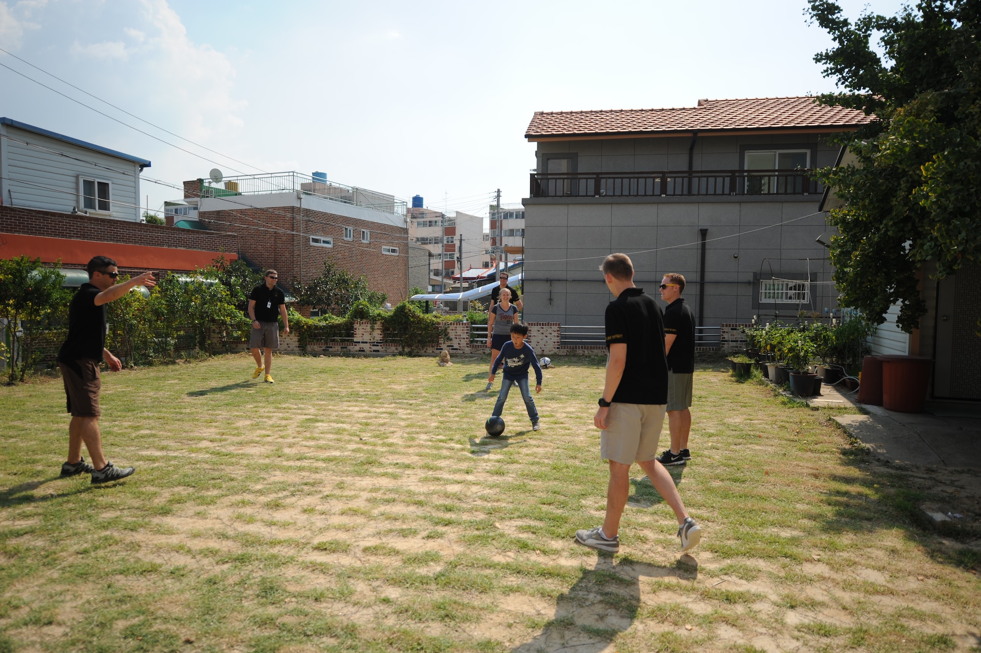 Airmen assigned to the 80th Fighter Squadron, 8th Fighter Wing, Kunsan Air Base, Republic of Korea, play soccer with children at a Gunsan City welfare facility Sept. 19, 2015. Approximately 20 volunteers played soccer, basketball and gonggi with elementary, middle and high school students. Organizations from the 8th FW regularly volunteer time to enhance relationships with the local community and make the wing better. (U.S. Air Force photo by Master Sgt. David Miller)