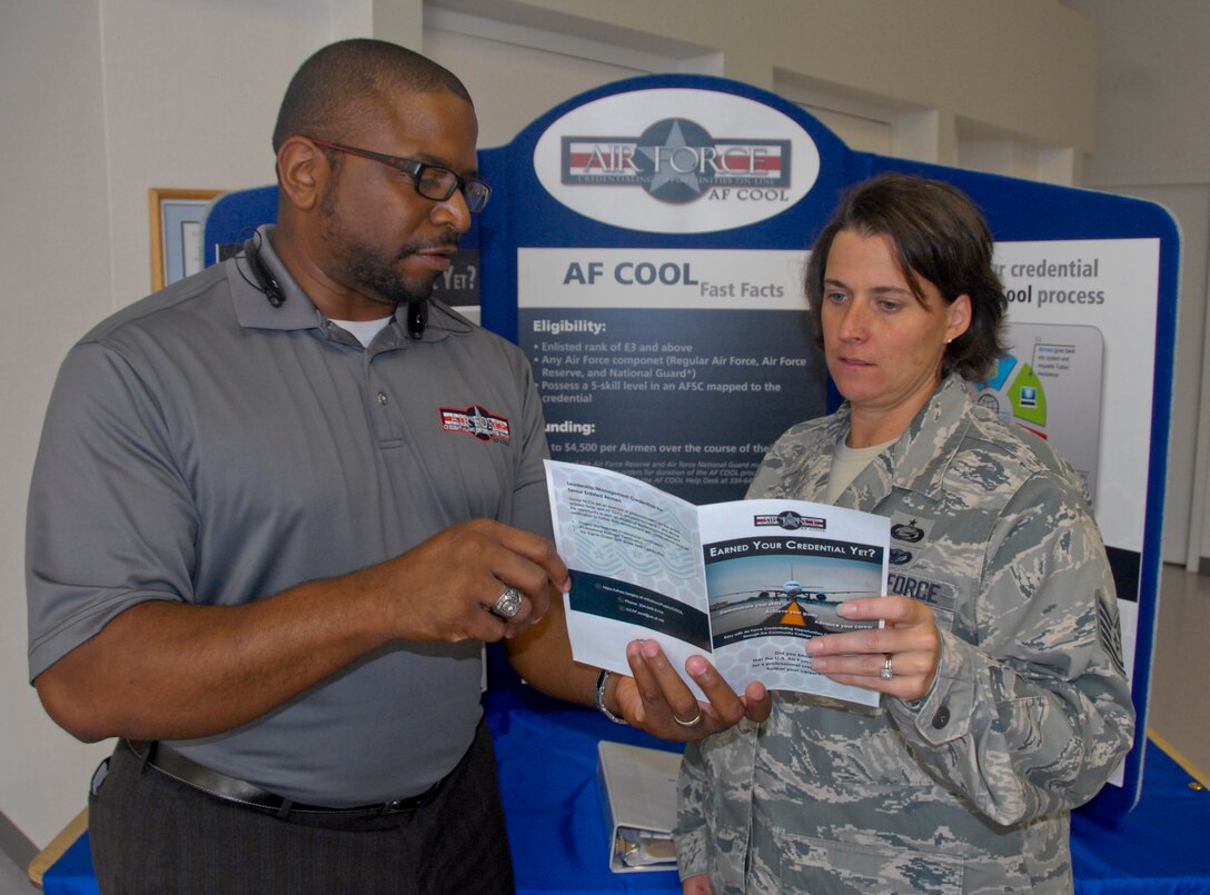 Russell Gray, Air Force Credentialing Opportunities On-Line director, explains the AF COOL program to an Airman following a briefing at Eglin Air Force Base, Fla. The Air Force Installation Contracting Agency recently partnered with Air University and The Barnes Center for Enlisted Education to deliver a follow-on contract for AF COOL. (U.S. Air Force photo/Kevin Gaddie)