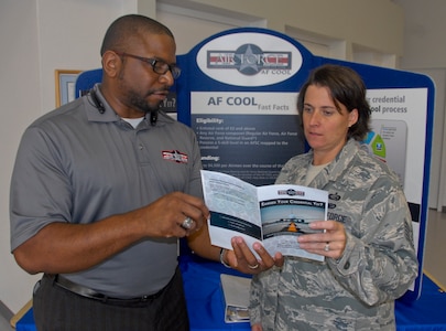 Russell Gray, Air Force Credentialing Opportunities On-Line director, explains the AF COOL program to an Airman following a briefing at Eglin Air Force Base, Fla. The Air Force Installation Contracting Agency recently partnered with Air University and The Barnes Center for Enlisted Education to deliver a follow-on contract for AF COOL. (U.S. Air Force photo/Kevin Gaddie)