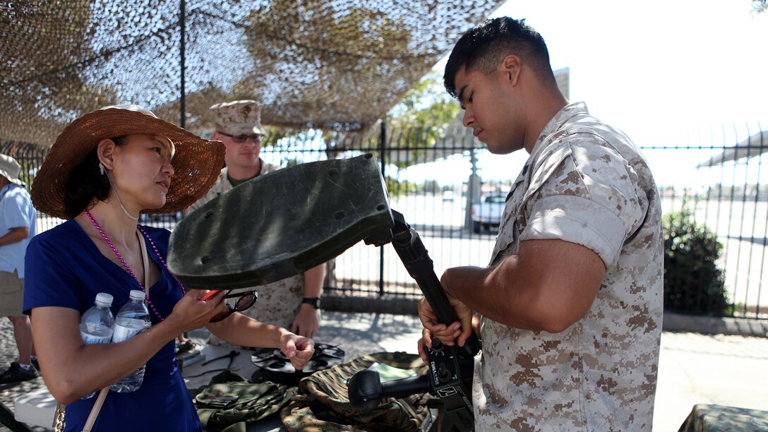 An explosive ordnance disposal Marine explains how a metal detector works to an onlooker during San Diego Fleet Week 2015 at Naval Base Coronado, Calif., Sept. 20, 2015. Thirty-seven Marines from 7th ESB presented static displays during the event to demonstrate the quality of military assets to the citizens of San Diego.