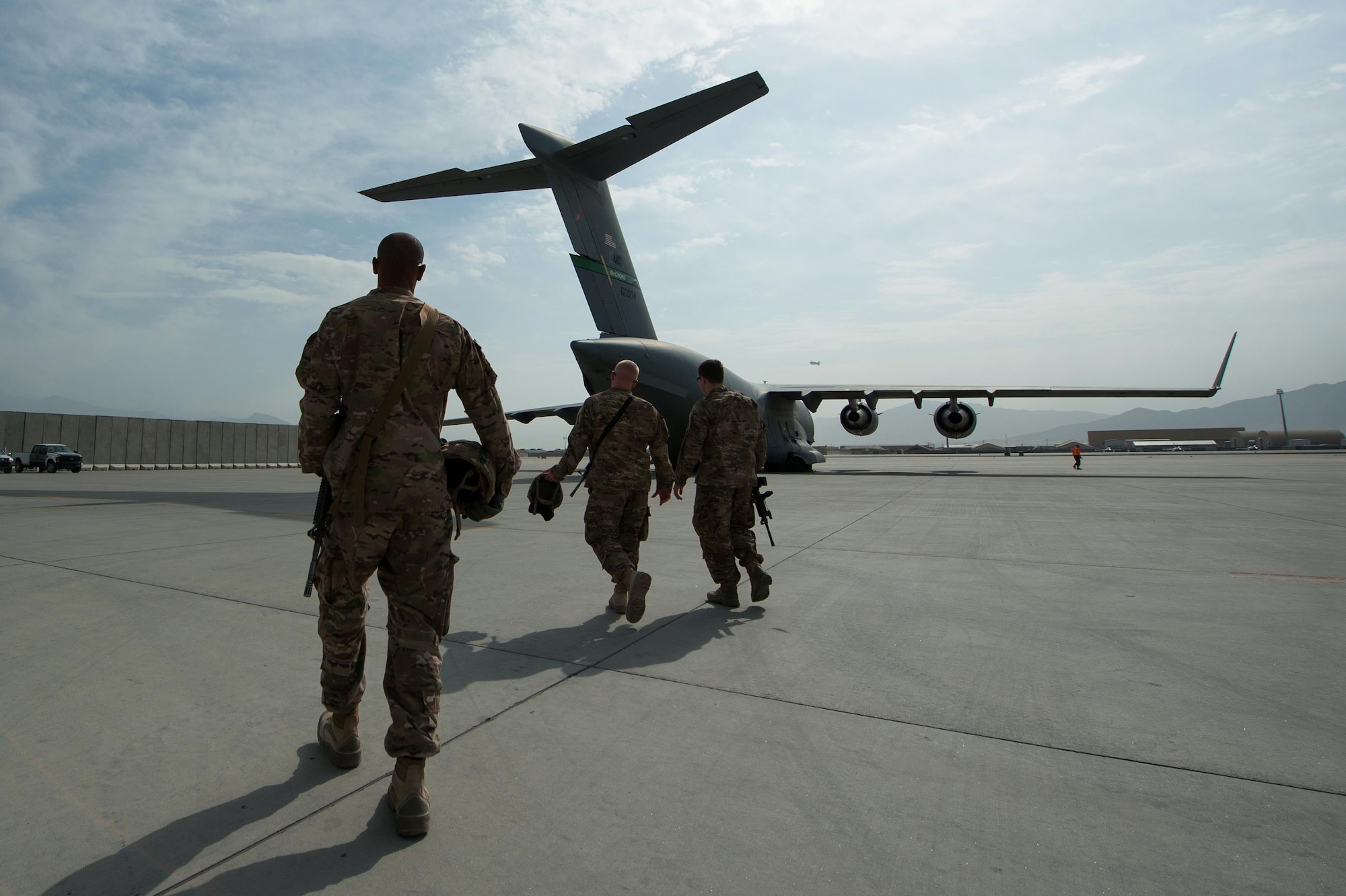 U.S. Soldiers assigned to the 1st Armored Division Resolute Support Sustainment Brigade walk to an Air Force C-17 Globemaster III aircraft to unload Mine-Resistant Ambush Protected vehicle at Bagram Airfield, Afghanistan, Sept. 21, 2015. USAF cargo aircraft have transported 31,500 short tons of cargo throughout Afghanistan this year (U.S. Air Force photo by Tech. Sgt. Joseph Swafford/Released)