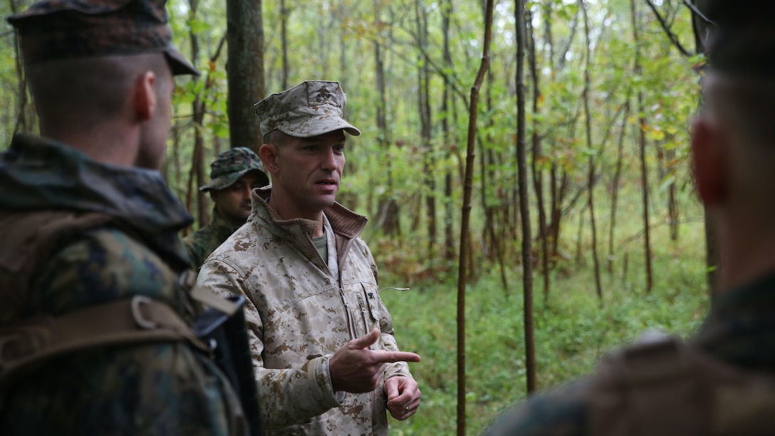 Col. Morgan G. Mann, deputy commander of 25th Marine Regiment, 4th Marine Division, Marine Forces Reserve, speaks to Marines with Charlie Company, 1st Battalion, 25th Marine Regiment and members of the Canadian Army Royal Hamilton Light Infantry, Wentworth Regiment, after a patrolling engagement with another platoon Sept. 12, 2015, during exercise Lake Effect. Mann commented on the way the Marines and Canadians reacted to an ambush assault by another platoon.