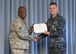 United States Navy Supply Corps Lt. Cmdr. Alexander Kaczur, DLA Distribution Current Operations executive officer, receives the Defense Meritorious Service Award from DLA Distribution commander Army Brig. Gen. Richard Dix.