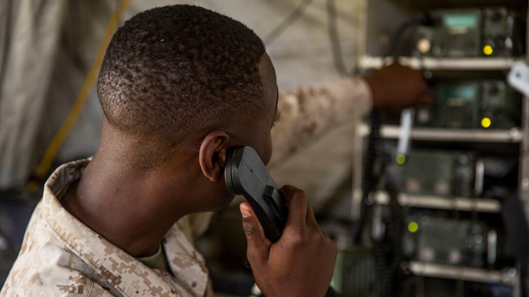 Cpl. Jemarco Harris, a field radio operator with 10th Marine Regiment, 2nd Marine Division talks on a radio during Operation Firestorm, a week-long exercise to prepare the regiment for their upcoming exercise, Rolling Thunder, at Camp Lejeune, N.C., Aug. 16, 2015. This exercise ensures that each artillery battery are ready to push out whenever they need to and that the supporting units are able to do their jobs when the regiment gets to Fort Bragg for Rolling Thunder. 