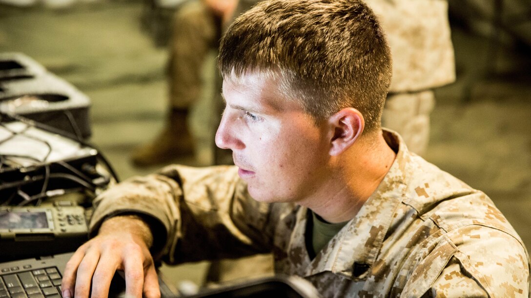 Cpl. Christopher Bredow, a field artillery fire controlman with 10th Marine Regiment, 2nd Marine Division looks over notional fields of fire during Operation Firestorm, an exercise to prepare the regiment for their upcoming exercise, Rolling Thunder, at Camp Lejeune, N.C., Aug. 16, 2015. The operation is a week-long field operation and is designed to ensure that communication and logistics capabilities are up to par before pushing out to Fort Bragg for Rolling Thunder. 