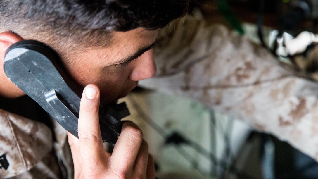 Cpl. Dustin Lewis, a field radio operator with 10th Marine Regiment, 2nd Marine Division talks on a radio during Operation Firestorm, a week-long exercise to prepare the regiment for their upcoming exercise, Rolling Thunder, at Camp Lejeune, N.C., Aug. 16, 2015. This exercise ensures that each artillery battery are ready to push out whenever they need to and that the supporting units are able to do their jobs when the regiment gets to Fort Bragg for Rolling Thunder. 