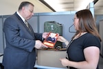 DLA historians Harold Raugh (left) and Chrissie Reilly review a DLA Energy historical photo that was found in one of 23 archival boxes of photographs and negatives donated to the DLA archives. More than 6,000 historic photos and negatives documenting the evolution and development of the Defense Fuel Supply Center were given to the DLA archives.