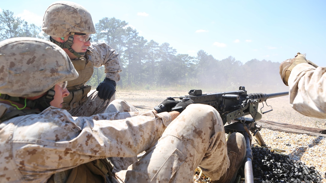 Lance Cpl. Joshua Arntzen (front), a radio operator, Battery M, 3rd Battalion, 14th Marine Regiment, Marine Forces Reserve and Cpl. Jeffrey Mallone, a field wireman with Battery M, man the M250 machine gun on Pelham Range in Anniston, Ala., on Sept. 19, 2015. The Marines trained on three different crew-served weapons to maintain their proficiency and knowledge on each system.