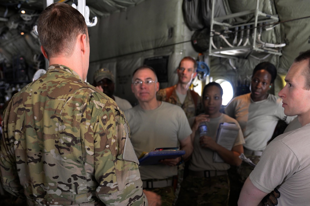 U.S. Air Force Capt. Matt Buchholtz, left, gives a pre-flight briefing to aeromedical evacuation team members before taking off on a medical evacuation mission from Bagram Airfield, Afghanistan, Sept. 3, 2015. Buchholtz, a pilot assigned to the 774th Expeditionary Airlift Squadron, flies various combat missions throughout Afghanistan supporting operations ranging from medical evacuations to cargo and passenger transports. U.S. Air Force photo by Senior Airman Cierra Presentado