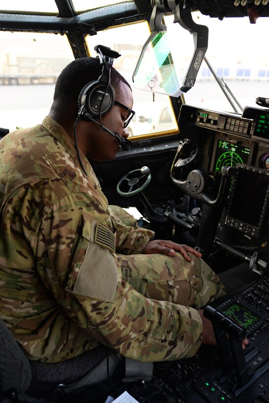 U.S. Air Force Capt. Boston McClain III turns on the controls inside a C-130J Super Hercules aircraft in preparation for take-off on Al Udeid Air Base, Qatar, Sept. 4, 2015. McClain III is a pilot assigned to the 774th Expeditionary Airlift Squadron. U.S. Air Force photo by Senior Airman Cierra Presentado