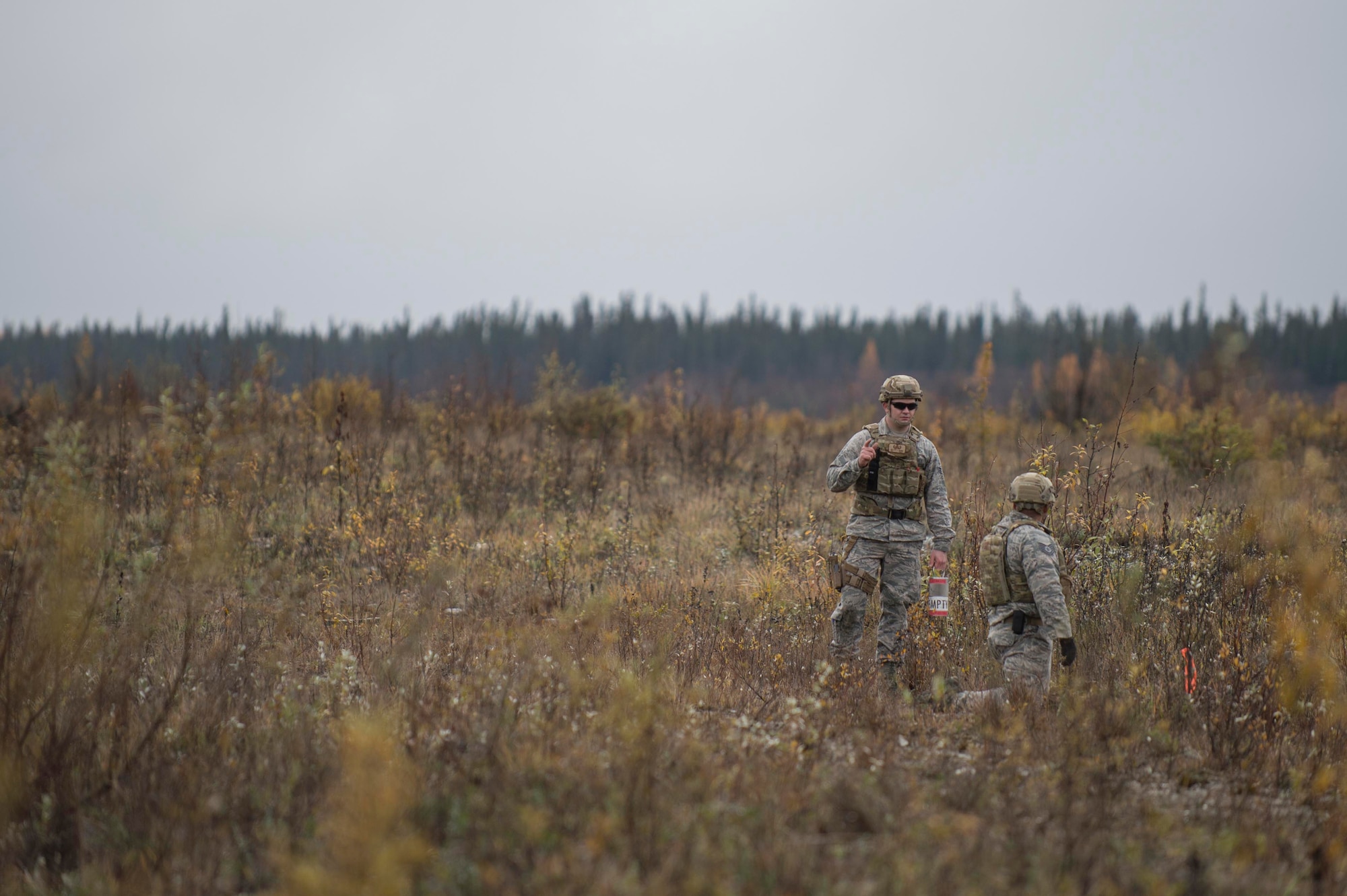 Airman 1st Class Dillon Babb and Tech. Sgt. Michael Alexander II, both are 354th Civil Engineer Squadron explosive ordinance disposal technicians from Eielson Air Force Base, Alaska, prepare to blow up one of four buckets containing 65 sticks deteriorating dynamite removed from a garage in Delta Junction, Alaska, Sept. 20, 2015. Eielson’s EOD technicians, who form the smallest operational flight in the Air Force, respond around the northern part of the state covering an area of responsibility larger than the state of Texas when local civil authorities call for the mutual aid. (U.S. Air Force photo/Staff Sgt. Shawn Nickel)