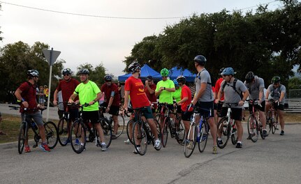 Competitors prepare for the start of the 22-mile bike race portion of the annual Rambler 120 competition Sept. 19, 2015 at Joint Base San Antonio Recreation Park at Canyon Lake. The Rambler 120, which is hosted by the 502nd Force Support Squadron, features four- and eight-person teams that engage in a friendly, but hard-fought, competition that challenges participants with a 22-mile bike race, 6-mile run, 2-mile raft race and a mystery event. (U.S. Air Force photo by Edward Dixon)