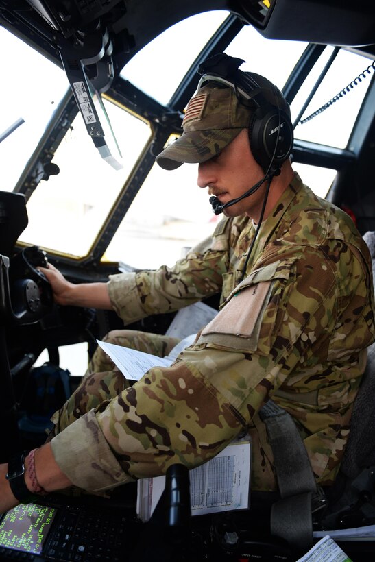 U.S. Air Force Capt. Matt Buchholtz turns on the controls inside a C-130J Super Hercules aircraft in preparation for take-off on Al Udeid Air Base, Qatar, Sept. 4, 2015. Buchholtz is a pilot assigned to the 774th Expeditionary Airlift Squadron. U.S. Air Force photo by Senior Airman Cierra Presentado