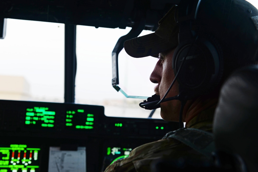 U.S. Air Force Capt. Matt Buchholtz turns on the controls inside a C-130J Super Hercules aircraft in preparation for take off on Al Udeid Air Base, Qatar, Sept. 4, 2015. Buchholtz is a pilot assigned to the 774th Expeditionary Airlift Squadron. U.S. Air Force photo by Senior Airman Cierra Presentado
