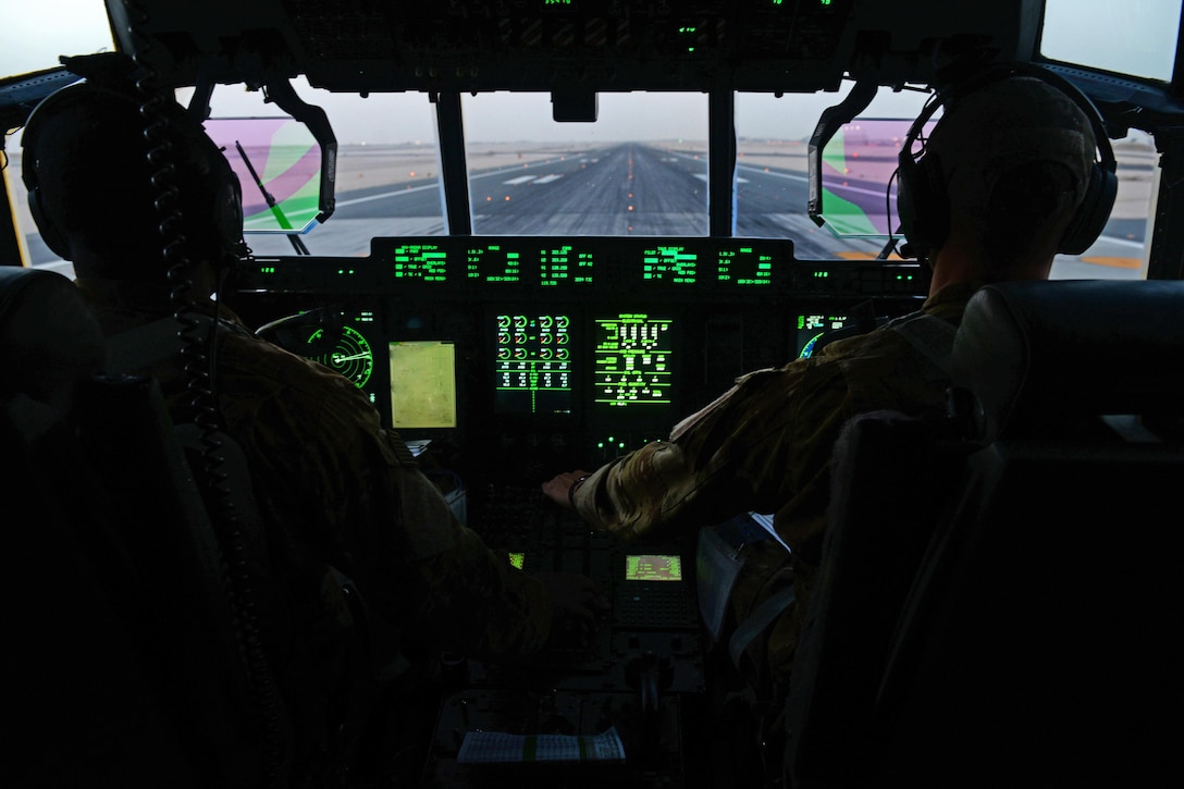 U.S. Air Force Capts. Boston McClain and Matt Buchholtz take off in a C-130J Super Hercules aircraft for Bagram Airfield, Afghanistan, Sept. 3 2015, from Al Udeid Air Base, Qatar. McClain and Buchholtz are pilots assigned to the 774th Expeditionary Airlift Squadron. U.S. Air Force photo by Senior Airman Cierra Presentado