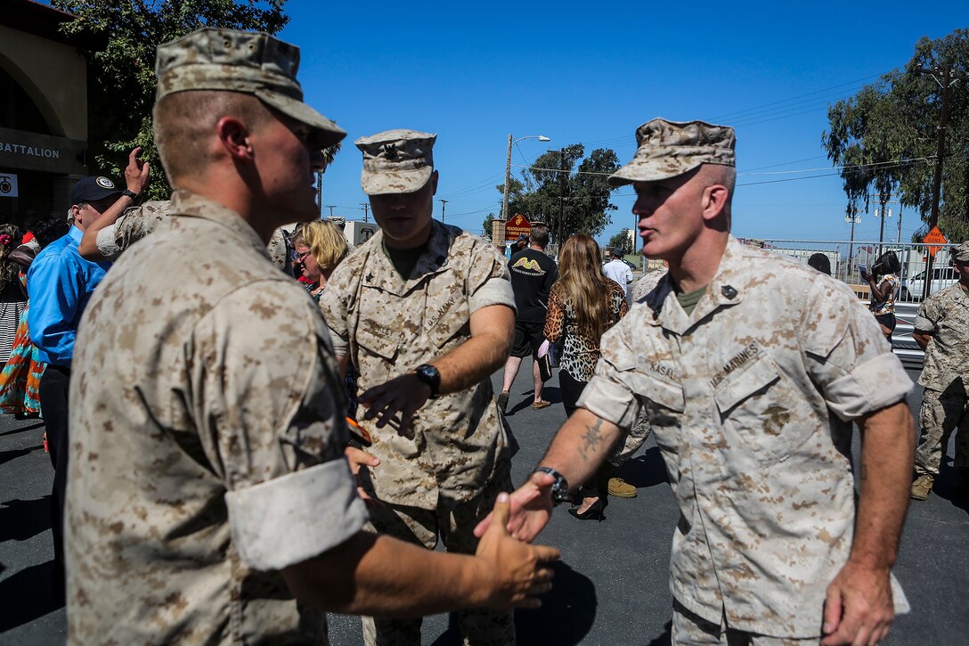 Sergeant Maj. Bradley Kasal, Sergeant Major of I Marine Expeditionary Force, congratulates new graduates from Field Medical Battalion-West during the 65th anniversary celebration of the training institution, and graduation ceremony of Field Medical Service Technician Class 2015-040, aboard Marine Corps Base Camp Pendleton, Calif., Sept. 18, 2015. FMTB-West opened its doors in the fall of 1950 and has trained young Sailors on life-saving techniques utilized on battlefields throughout history. (U.S. Marine Corps Photo by Sgt. Rick Hurtado / Released).