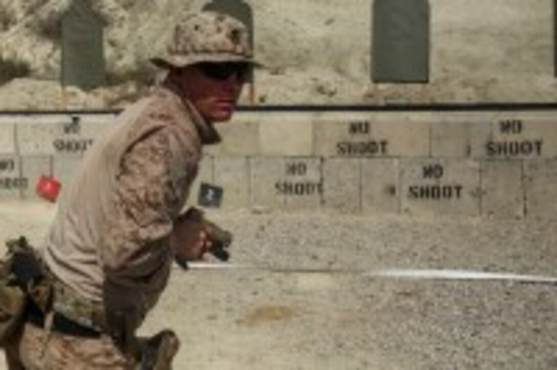 A Marine with Company A, 1st Reconnaissance Battalion, 1st Marine Division, surveys his area after firing a Colt M45 pistol during weapons familiarization training aboard Marine Corps Base Camp Pendleton, Calif., Sept. 9, 2015. The 2-week training schedule was used to build on basic infantry skills for an upcoming deployment with a Marine Expeditionary Unit. (U.S. Marine Corps photo by Cpl. Tony Simmons)