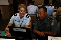 U.S. Air Force Maj. Leah Sprecher, Pacific Air Forces legal planner and Tentara Nasional Indonesia legal planner, and TNI Maj. Slamet discuss urban search and rescue legal considerations during exercise Gema Bhakti. Gema Bhakti, Indonesian for 'Echo of Good Deeds,' is a 10-day exercise designed to promote positive military relations, increase cultural awareness and enhance training and understanding of each other's capabilities. (U.S. Air Force photo by Capt. Joel Banjo-Johnson/Released)