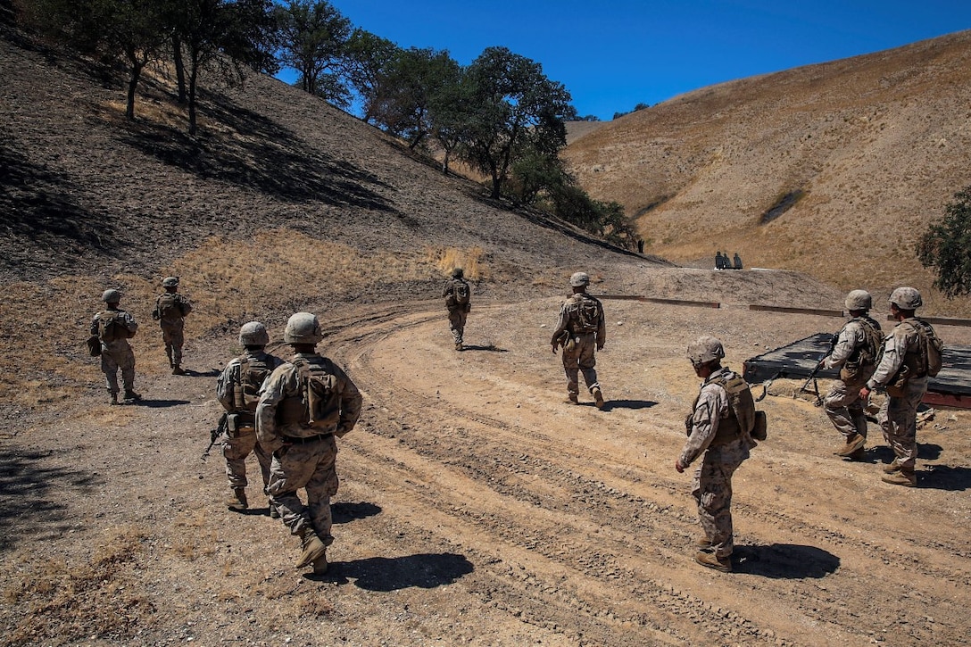 Marines with 1st Combat Engineer Battalion, 1st Marine Division, I Marine Expeditionary Force, patrol a range for live fire and maneuver training during Exercise Pioneer Express at Camp Roberts, Calif., Sept. 7, 2015. The exercise provides an opportunity for both individual and collective training for the Marines and the unit and ensures they remain equipped, ready and relevant for future operations. (U.S. Marine Corps photo by Lance Cpl. Caitlin Bevel)