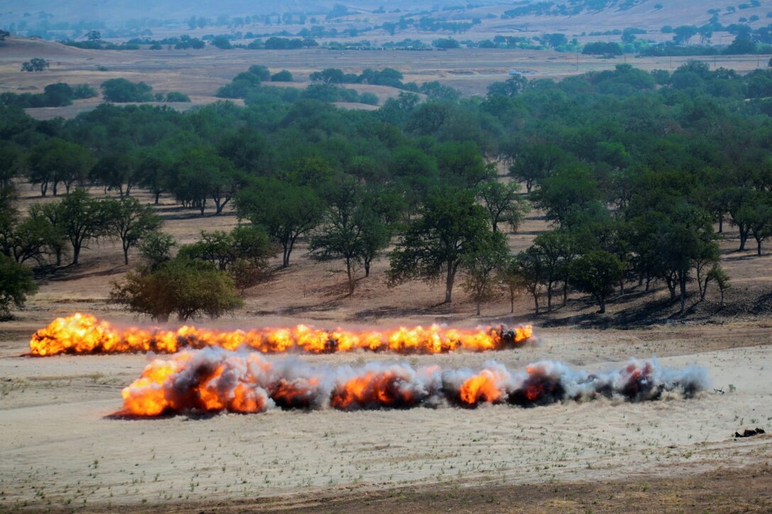 Marines with 1st Combat Engineer Battalion, 1st Marine Division, I Marine Expeditionary Force, fire antipersonnel obstacle breaching systems during Exercise Pioneer Express at Camp Roberts, Calif., Sept. 8, 2015. The exercise prepares Marines to successfully execute expeditionary operations by refining command and control methods, reconnaissance, mobility, counter-mobility and survivability operations. (U.S. Marine Corps photo by Lance Cpl. Caitlin Bevel)