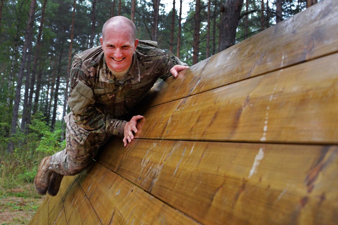 U.S. Army Sgt. Nathaniel Nicholas conducts the "team reaction lane" during the 2015 European Best Warrior Competition at the Grafenwoehr Training Area in Germany, Sept. 14, 2015. Nicholas is assigned to Company B, Allied Forces South Europe Battalion. U.S. Army photo by Gertrud Zach
 