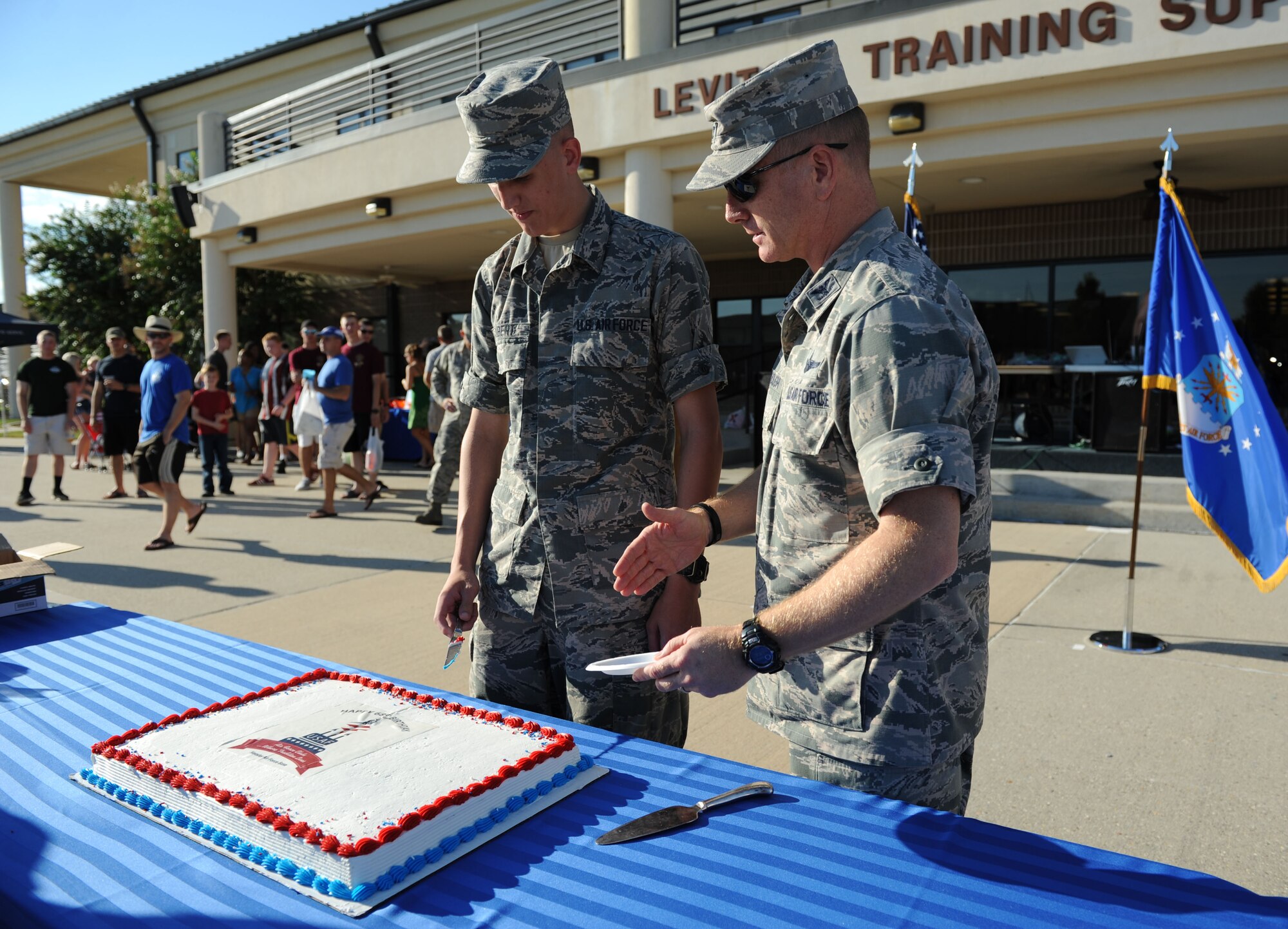 Airman Basic Kyle Shubert, 338th Training Squadron student and the youngest Airman at Keesler, assists Col. Dennis Scarborough, 81st Training Wing vice commander, with cutting the birthday cake during Keesler’s Air Force birthday celebration Sept. 18, 2015, Keesler Air Force Base, Miss. The event also included music, games, contests and food to celebrate the Air Force’s 68th birthday.  (U.S. Air Force photo by Kemberly Groue)