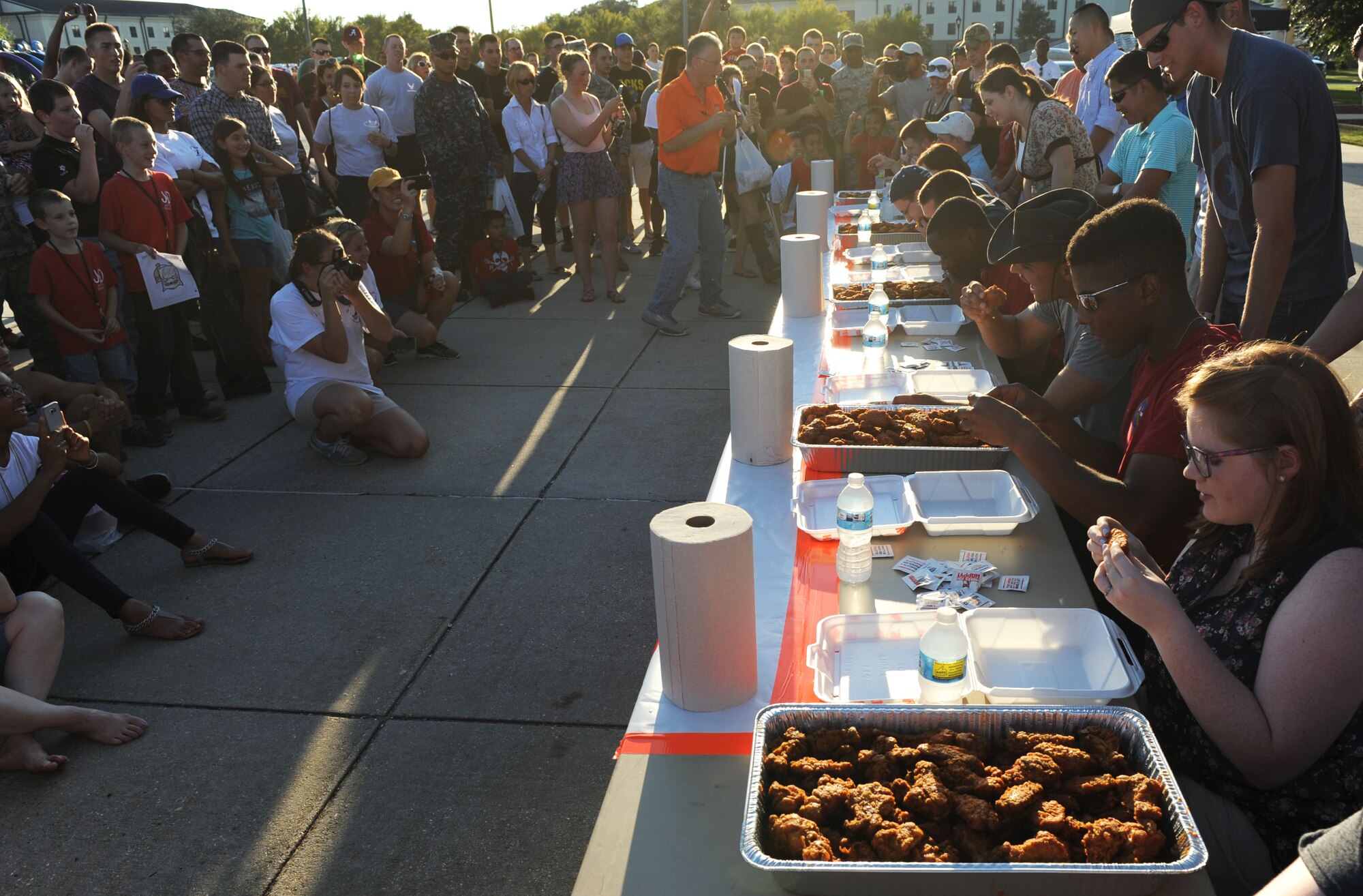 Keesler personnel cheer on Airmen as they compete in the hot wing eating contest during Keesler’s Air Force birthday celebration Sept. 18, 2015, Keesler Air Force Base, Miss. The event also included music, games, contests and food to celebrate the Air Force’s 68th birthday.  (U.S. Air Force photo by Kemberly Groue)