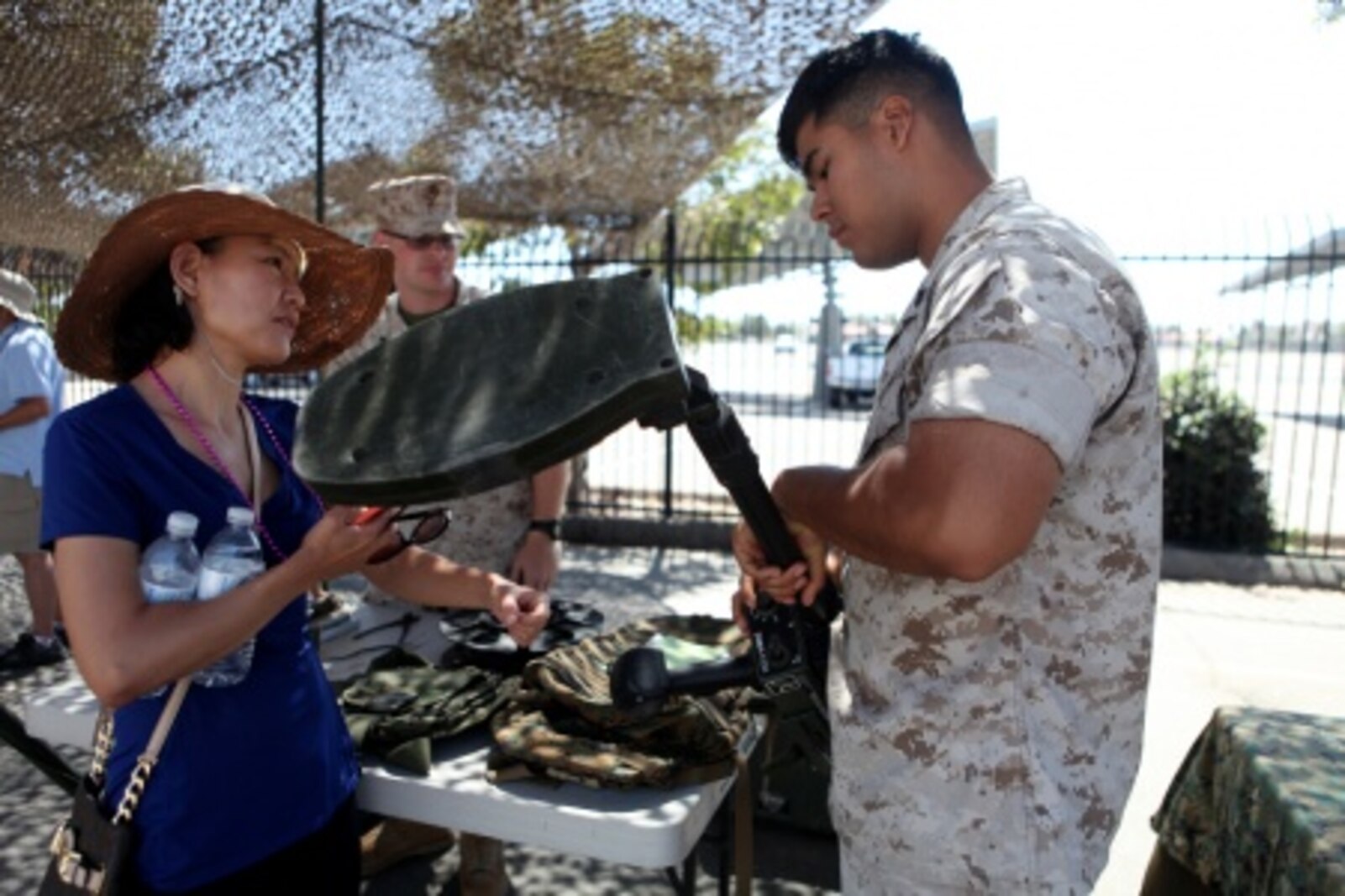 An explosive ordnance disposal Marine explains how a metal detector works to an onlooker during San Diego Fleet Week 2015 aboard Naval Base Coronado, Calif., Sept. 20, 2015. Thirty-seven Marines from 7th ESB presented static displays during the event to demonstrate the quality of military assets to the citizens of San Diego.