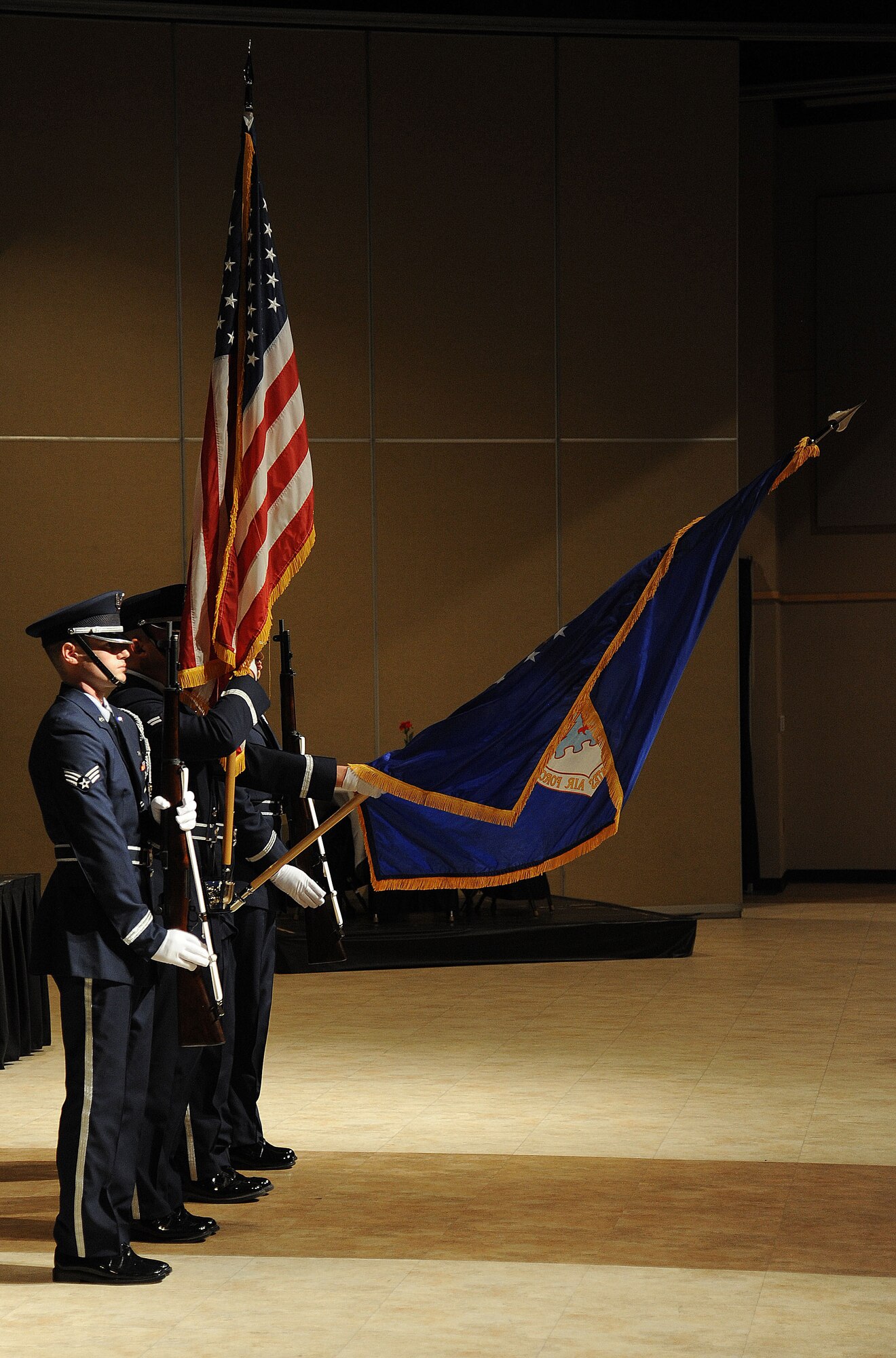 Goodfellow Air Force Base Honor Guard lower the Air Force flag in salutation to the national anthem during the Air Force Ball at the McNease Convention Center in San Angelo, Texas, Sept. 19, 2015. The color guard instilled a sense of patriotism in the crowd by performing multiple different ceremonies during the ball. (U.S. Air Force photo by Airman Caelynn Ferguson/Released)