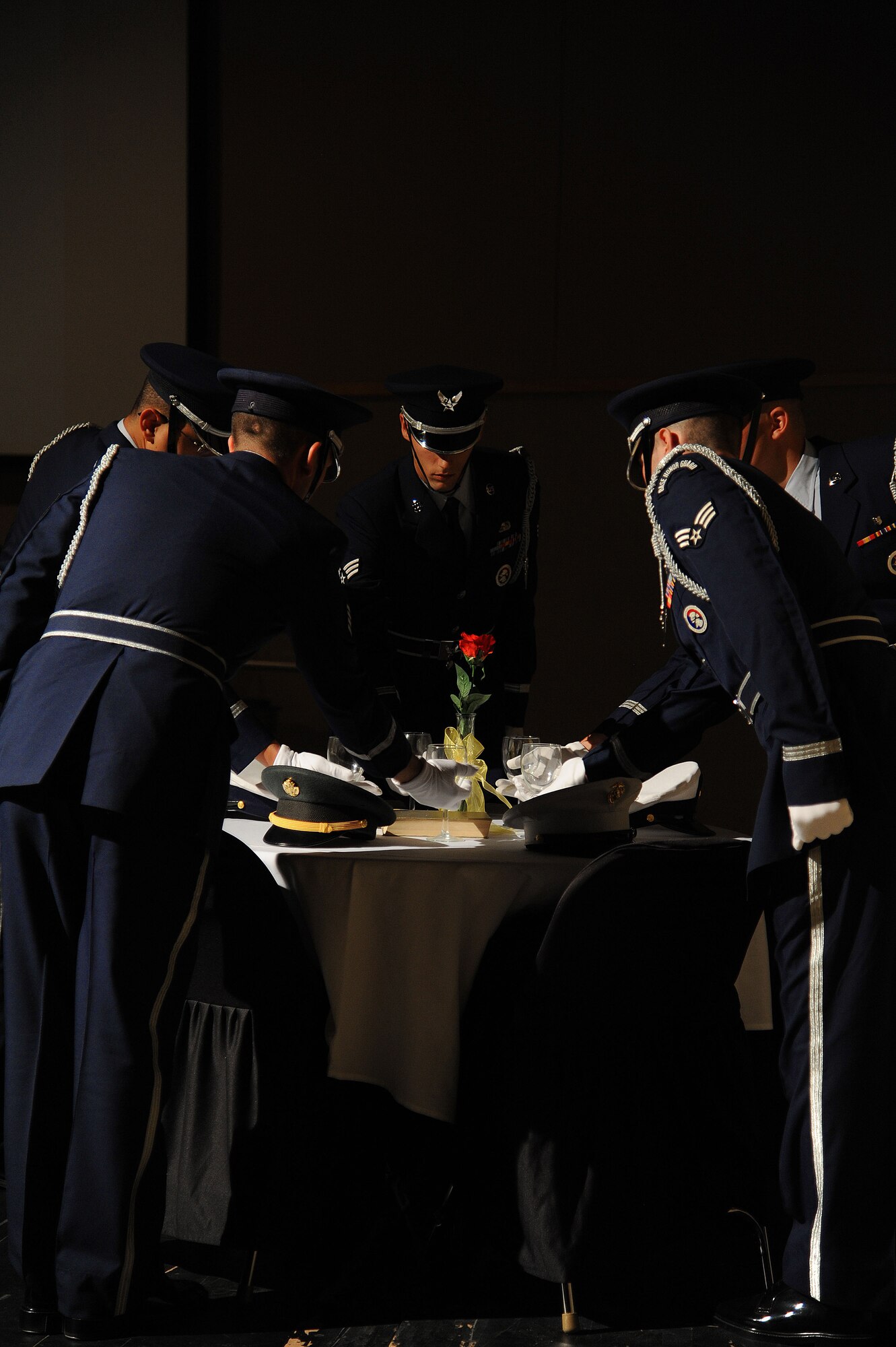 Goodfellow Air Force Base Honor Guard performs the Prisoners Of War/Missing In Action ceremony during the Air Force Ball at the McNease Convention Center in San Angelo, Texas, Sept. 18, 2015. A single red rose stands in the center of the table as symbol of the loved ones and families who await the return of their fallen service members. (U.S. Air Force photo by Airman Caelynn Ferguson/Released)