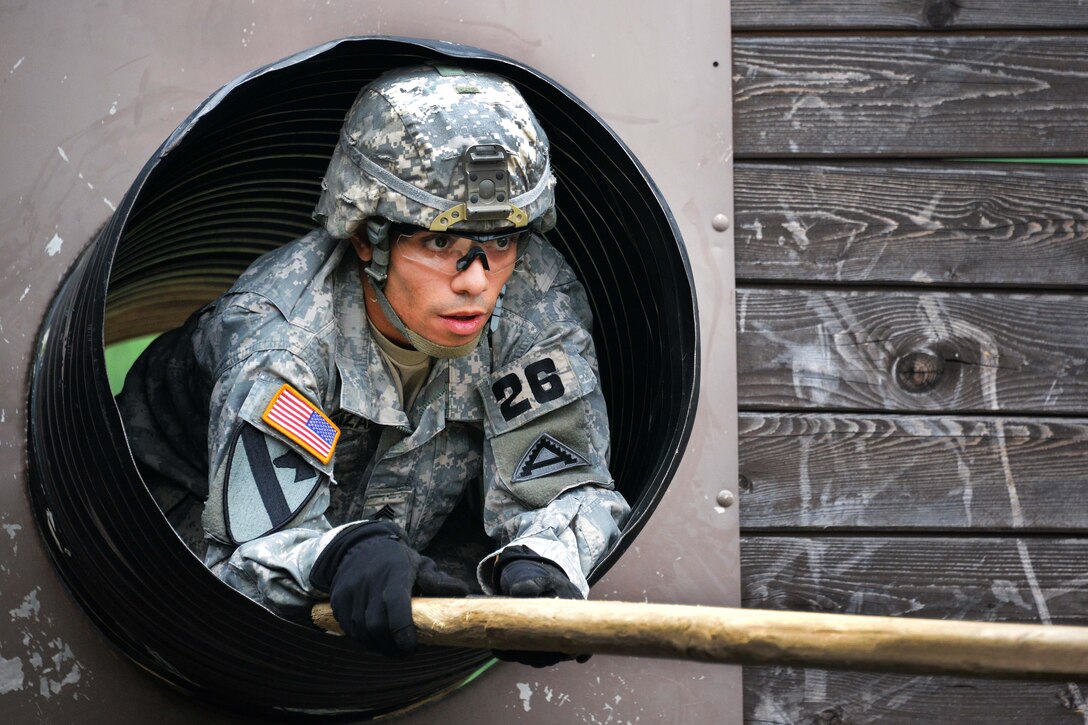 U.S. Army Sgt. Christian Gonzales participates in the "team reaction lane"  during the 2015 European Best Warrior Competition at the Grafenwoehr Training Area in Germany, Sept. 14, 2015. Gonzales is assigned to the Joint Multinational Readiness Center.  U.S. Army photo by Gertrud Zach