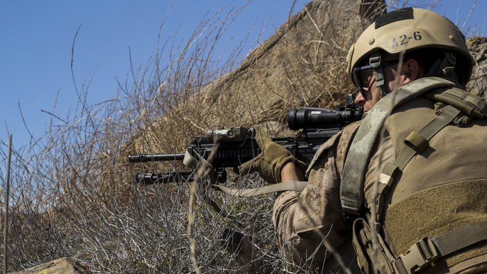 A Marine with Company A, 1st Reconnaissance Battalion, 1st Marine Division, fires behind cover at simulated targets during immediate action drills aboard Marine Corps Base Camp Pendleton, Calif., Sept. 9, 2015. The drills were part of a 2-week training schedule used to build on basic infantry skills for an upcoming deployment with a Marine Expeditionary Unit. (U.S. Marine Corps photo by Cpl. Tony Simmons/RELEASED)
