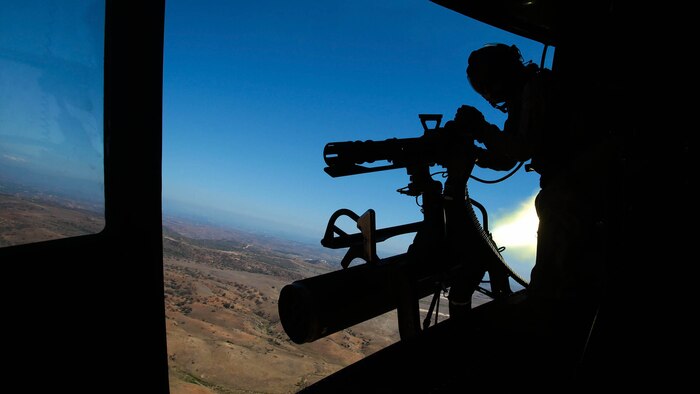 Donnelly, Idaho, native, Sgt. Elizabeth Azcuenaga, an enlisted aircrew training manager with Marine Light Attack Helicopter Squadron 169 (HMLA-169), Marine Aircraft Group 39, 3rd Marine Aircraft Wing, I Marine Expeditionary Force, fires a GAU-17 machine gun from the door of a UH-1Y Huey while the pilot simultaneously launches a rocket aboard Marine Corps Base Camp Pendleton, Calif., Sept. 17, 2015. Azcuenaga fired the weapon during a weapons proficiency range designed to help new pilots and crew chiefs become more effective with their respective weapons systems. 