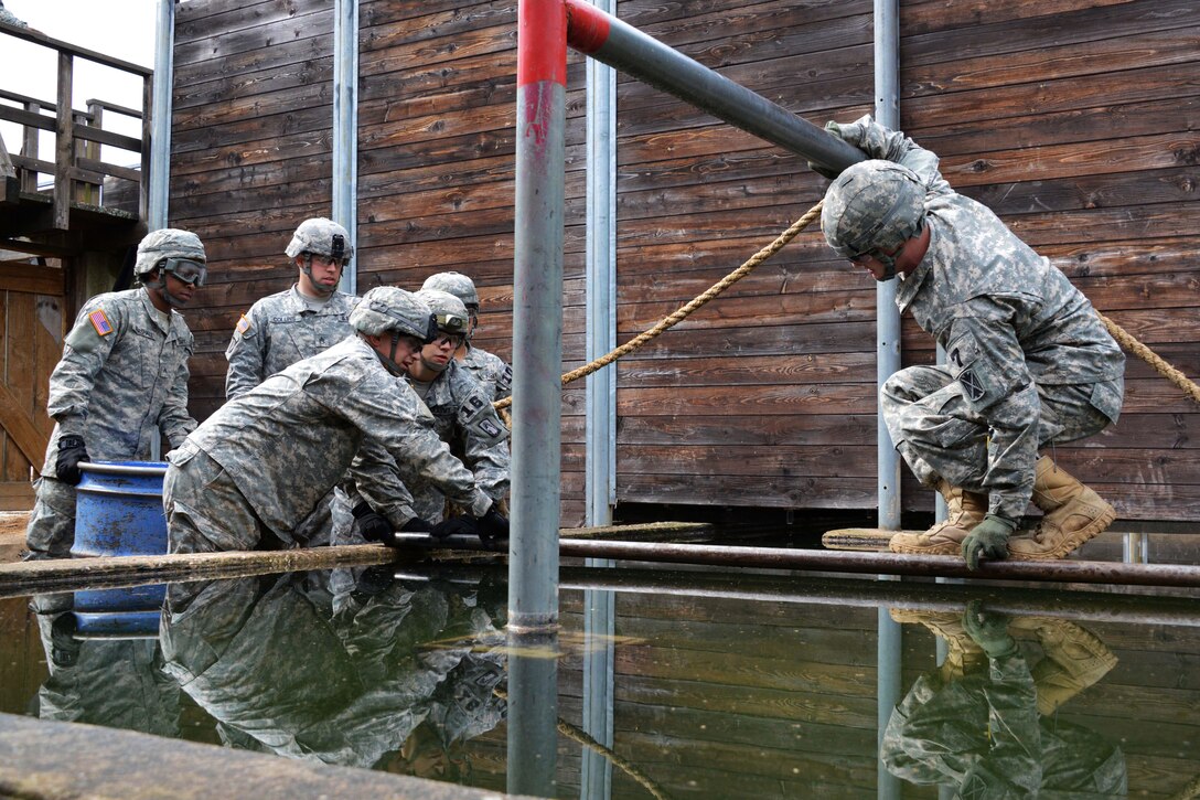 U.S. Army Spc. Julie Neff, right, participates in the "team reaction lane" during the 2015 European Best Warrior Competition at the Grafenwoehr Training Area in Germany, Sept. 14, 2015. Neff is assigned to 5th Battalion, 148th Aviation Regiment. U.S. Army photo by Gertrud Zach    