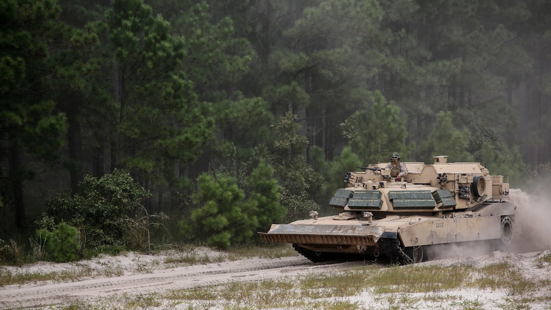 Marines with Alpha Company, 2nd Tank Battalion, depart the training area in an M1 Abrams tank following a vehicle breaching exercise aboard Engineer Training Area 2, Camp Lejeune, N.C., Sept. 17, 2015. The exercise brought together mechanized crews with 2nd Tanks and 2nd Combat Engineer Battalion to breach through and over a high berm.