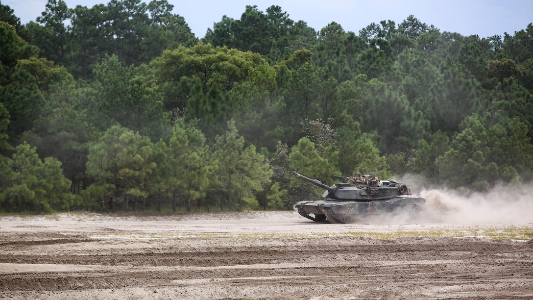Marines with Alpha Company, 2nd Tank Battalion, proceed to a berm in an M1 Abrams tank during a vehicle breaching exercise aboard Engineer Training Area 2, Camp Lejeune, N.C., Sept. 17, 2015. The exercise brought together mechanized crews with 2nd Tanks and 2nd Combat Engineer Battalion to breach through and over a high berm. 