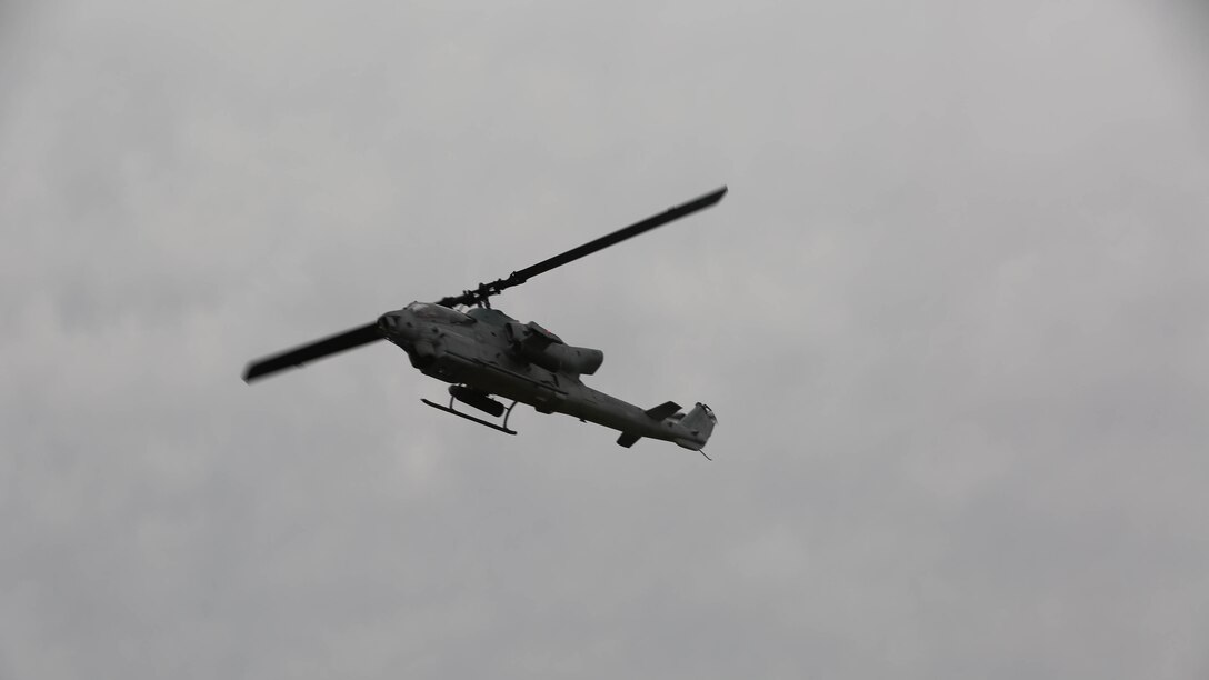 An AH-1 Cobra flies over observation point 2 after receiving approval to give air support during fire support training on Camp Lejeune, N.C., Sept. 17, 2015. Before suppressing enemy targets, the fire support coordination center must approve the plans and choice of asset.
