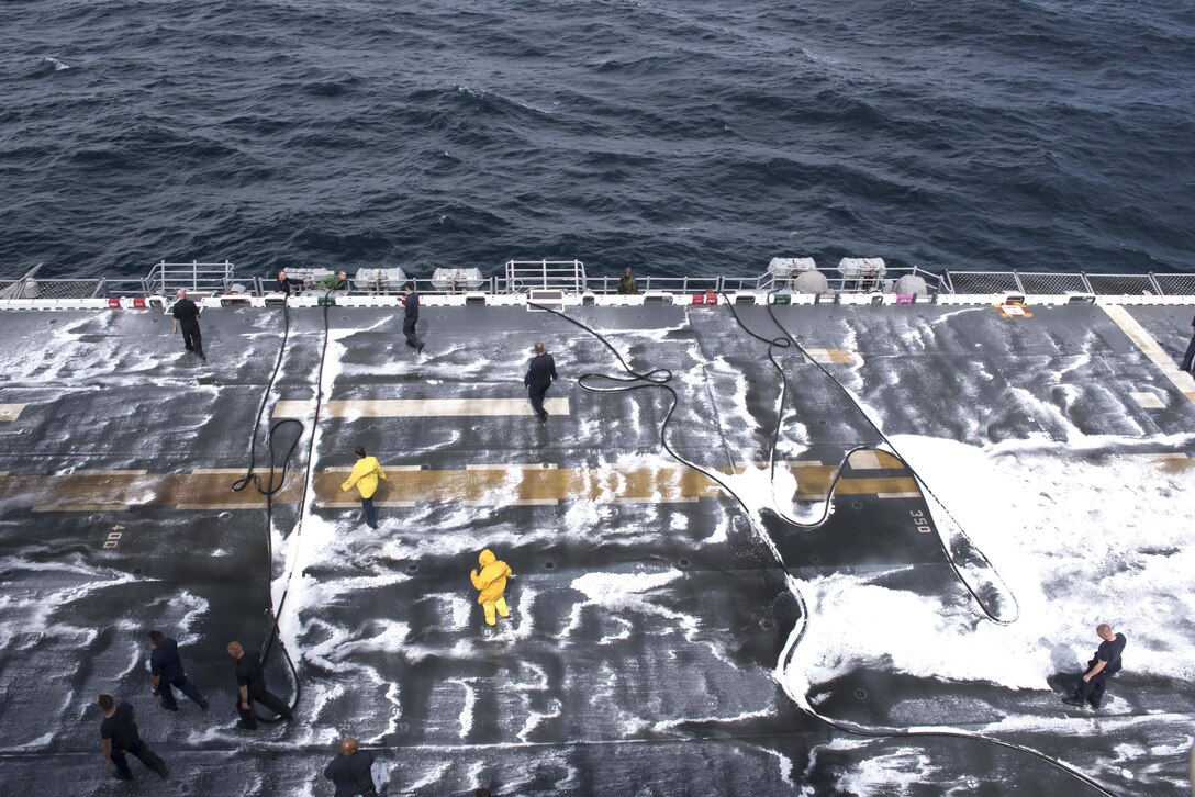 U.S. sailors aboard the USS Wasp wash the deck in the Atlantic Ocean, Sept. 21, 2015. The Wasp is conducting drills in preparation for a shipwide inspection this fall. U.S. Navy photo by Petty Officer 3rd Class Zhiwei Tan