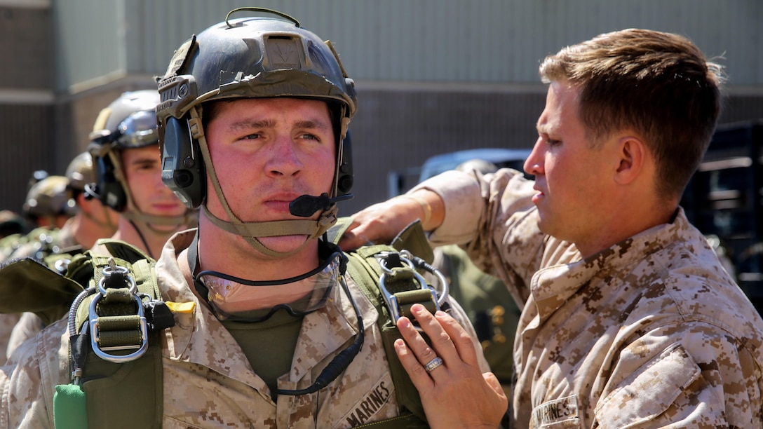 Sgt. Trevor Pace, an assistant team leader with Force Reconnaissance Company, 1st Reconnaissance Battalion, 1st Marine Division, receives a final inspection of his gear prior to parachute familiarization training at Marine Corps Base Camp Pendleton, Calif., Sept. 17, 2015. The goal of the training was to sharpen a skill set that is of great advantage to expeditionary forces, allowing the jumpers to infiltrate locations where access would be too difficult for vehicles.