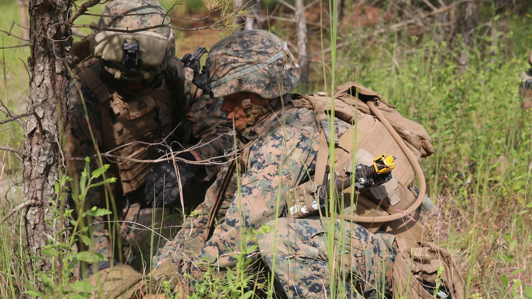 Corporal Jacob Powers (right), a section leader with 2nd Marine Regiment, and Lance Cpl. Michael Espinal (left), a squad leader with the unit, set up and conceal a simulated grapeshot charge during a battalion deployment for training exercise aboard Camp Lejeune, N.C., Sept. 16, 2015. The Marines used simulated explosives and other obstacles to hold their positions during the defensive portion of the exercise.