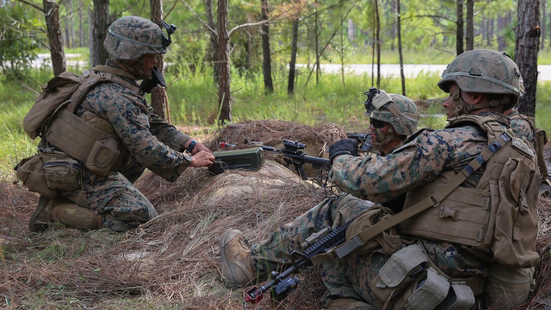 Corporal Jacob Powers (left), a section leader with 2nd Marine Regiment, instructs Marines in his section on building an improvised grapeshot charge during a battalion deployment for training exercise aboard Camp Lejeune, N.C., Sept. 16, 2015. Shrapnel charges such as grapeshot, used in conjunction with other obstacles, are defensive features instrumental to limiting enemy movement and securing a position.