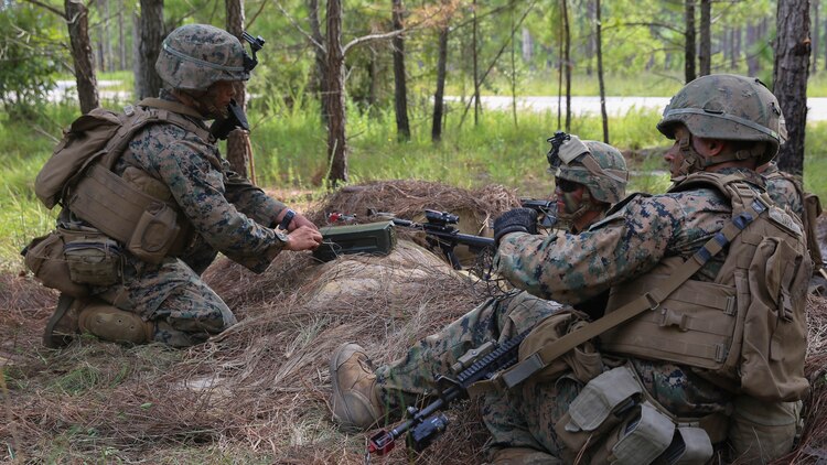 Corporal Jacob Powers (left), a section leader with 2nd Marine Regiment, instructs Marines in his section on building an improvised grapeshot charge during a battalion deployment for training exercise aboard Camp Lejeune, N.C., Sept. 16, 2015. Shrapnel charges such as grapeshot, used in conjunction with other obstacles, are defensive features instrumental to limiting enemy movement and securing a position.