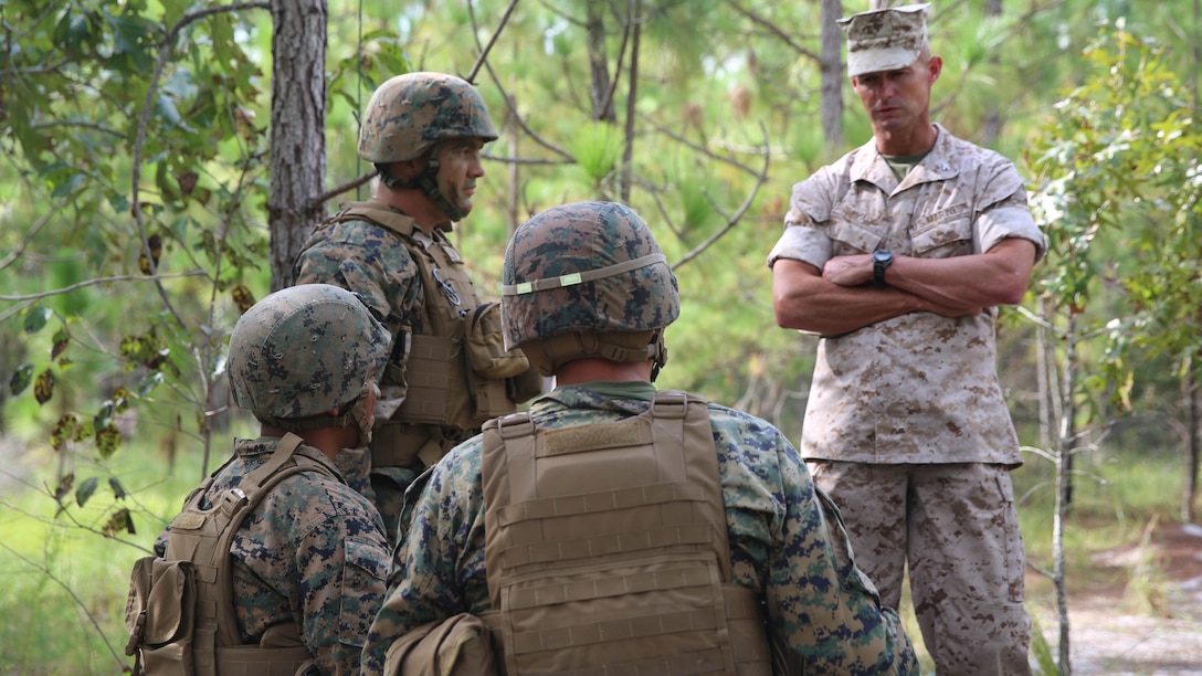 Colonel Thomas Savage, the commanding officer of 2nd Marine Regiment, speaks to Marines with 2nd Battalion, 2nd Marine Regiment, during a battalion deployment for training exercise aboard Camp Lejeune, N.C., Sept. 16, 2015. Savage and Sgt. Maj. James Boutin, the regimental sergeant major of 2nd Marines, visited the battalion in the field to show their support and dedication to the Marines under their command.